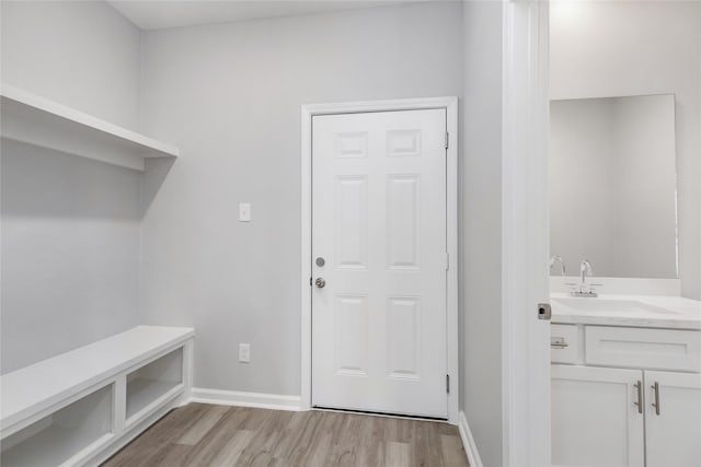 786 Lucky St, Houston, TX 77088 - mudroom with a sink, light wood-style floors, and baseboards