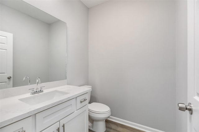786 Lucky St, Houston, TX 77088 - bathroom with toilet, wood finished floors, vanity, and baseboards