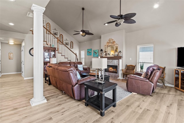 23313 San Luis Pass Rd, Galveston, TX 77554 - living room with decorative columns, light wood-type flooring, stairway, ceiling fan, and a premium fireplace