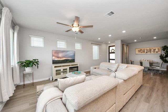 10053 Cloud Mist Dr, Houston, TX 77080 - living room with healthy amount of natural light, ceiling fan, baseboards, recessed lighting, and wood finished floors