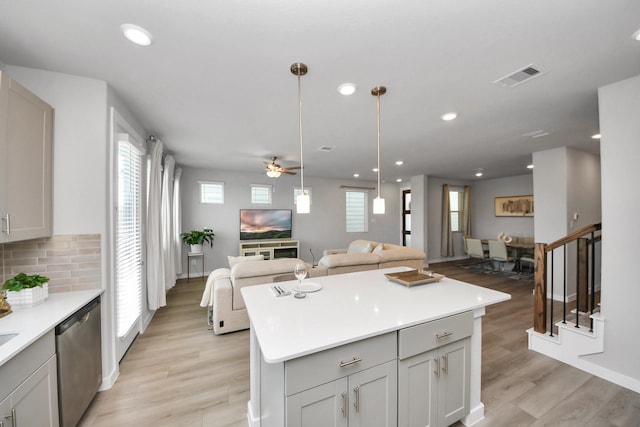 10053 Cloud Mist Dr, Houston, TX 77080 - kitchen with stainless steel dishwasher, open floor plan, light wood finished floors, plenty of natural light, and recessed lighting