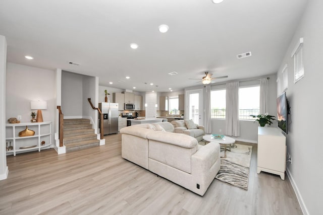 10053 Cloud Mist Dr, Houston, TX 77080 - living room with baseboards, light wood-style floors, stairs, ceiling fan, and recessed lighting