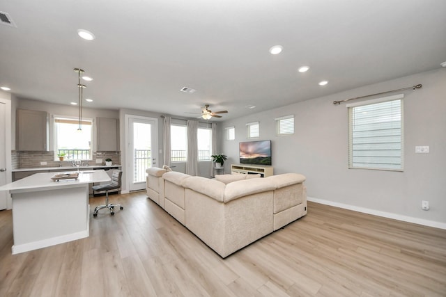 10053 Cloud Mist Dr, Houston, TX 77080 - living area with recessed lighting, light wood-type flooring, ceiling fan, and baseboards