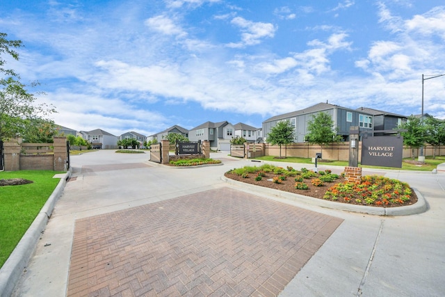 10053 Cloud Mist Dr, Houston, TX 77080 - view of decorative street featuring a residential view, curbs, a gated entry, street lights, and a gate