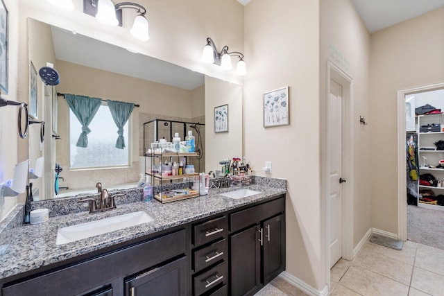 8014 Grove Sky Ct, Richmond, TX 77407 - bathroom with double vanity, a shower stall, tile patterned flooring, a spacious closet, and baseboards