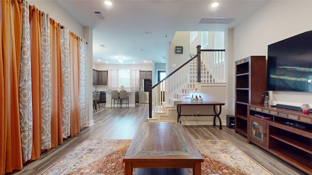 18622 Courteous Way, Cypress, TX 77433 - living room featuring stairs, wood finished floors, and recessed lighting