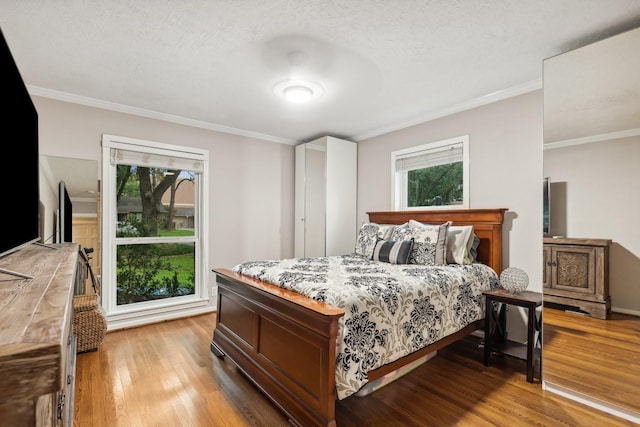 9623 Val Verde St, Houston, TX 77063 - bedroom featuring light wood-style flooring and ornamental molding