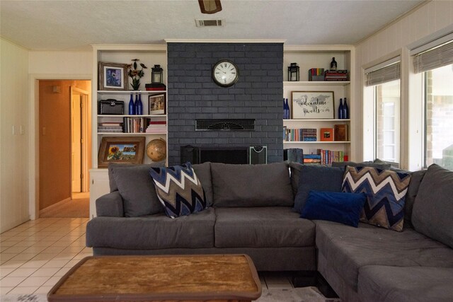5150 Sandy Creek Ln, Brenham, TX 77833 - tiled living room featuring ornamental molding, a brick fireplace, and built in features