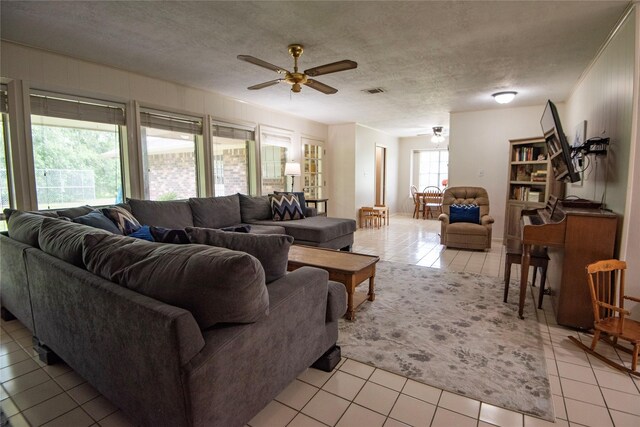 5150 Sandy Creek Ln, Brenham, TX 77833 - living area featuring a ceiling fan, light tile patterned flooring, and a textured ceiling