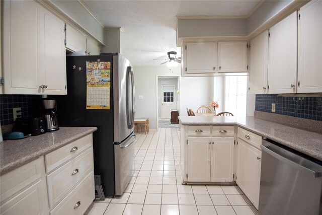 5150 Sandy Creek Ln, Brenham, TX 77833 - kitchen with appliances with stainless steel finishes, ceiling fan, light tile patterned floors, tasteful backsplash, and light countertops