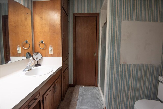 5150 Sandy Creek Ln, Brenham, TX 77833 - full bath featuring wallpapered walls, a shower stall, vanity, and toilet