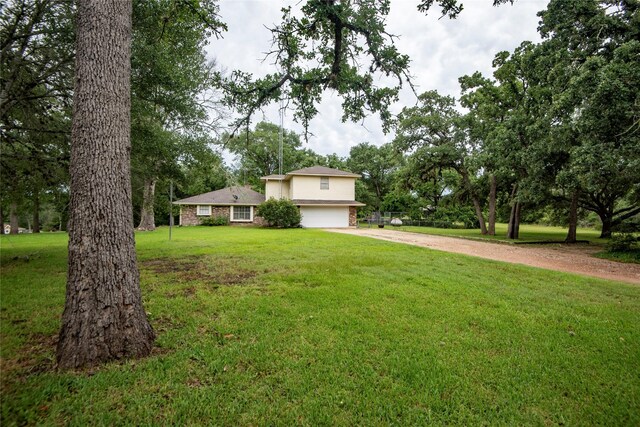 5150 Sandy Creek Ln, Brenham, TX 77833 - view of front of property featuring dirt driveway, a garage, and a front yard