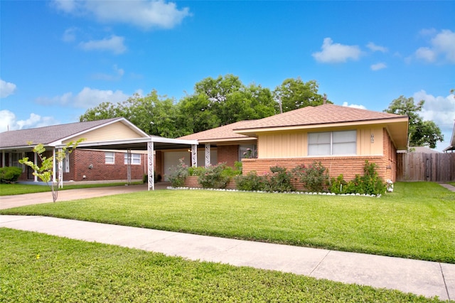 705 Kalmer St, Pasadena, TX 77502 - ranch-style house with brick siding, an attached carport, and driveway