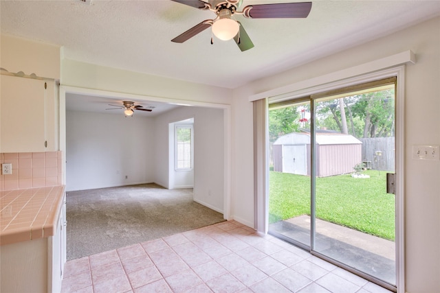 705 Kalmer St, Pasadena, TX 77502 - empty room featuring ceiling fan, light colored carpet, light tile patterned floors, and baseboards