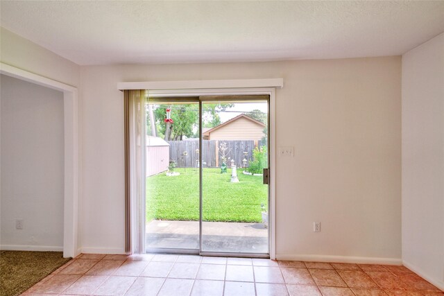 705 Kalmer St, Pasadena, TX 77502 - doorway to outside featuring baseboards and light tile patterned flooring