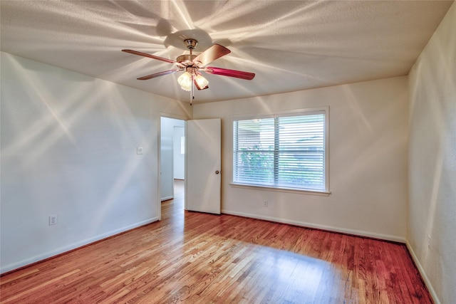 705 Kalmer St, Pasadena, TX 77502 - unfurnished room featuring wood finished floors, a ceiling fan, and baseboards
