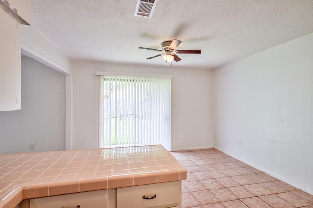 705 Kalmer St, Pasadena, TX 77502 - interior space featuring ceiling fan, light tile patterned floors, baseboards, and a textured ceiling