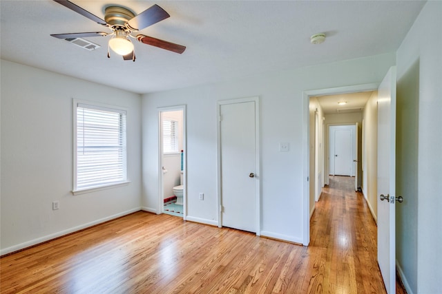 705 Kalmer St, Pasadena, TX 77502 - unfurnished bedroom featuring light wood-style floors, baseboards, attic access, connected bathroom, and ceiling fan