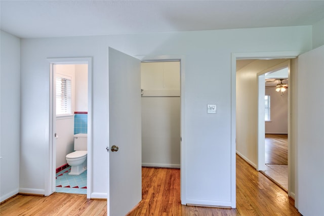 705 Kalmer St, Pasadena, TX 77502 - unfurnished bedroom featuring light wood-style floors, a closet, a walk in closet, and ensuite bathroom