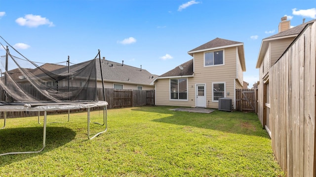 10811 Waterfern Ct, Houston, TX 77064 - rear view of house featuring a trampoline, central air condition unit, and a shingled roof