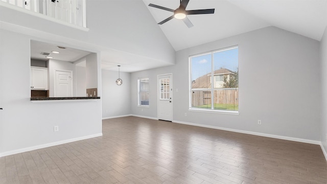 10811 Waterfern Ct, Houston, TX 77064 - unfurnished living room with a ceiling fan, wood finished floors, baseboards, and high vaulted ceiling