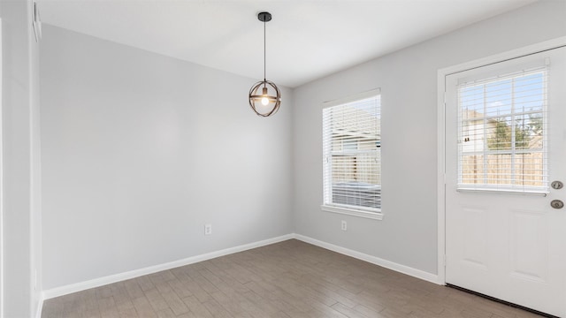 10811 Waterfern Ct, Houston, TX 77064 - unfurnished dining area featuring wood finished floors and baseboards