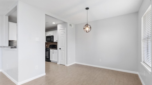 10811 Waterfern Ct, Houston, TX 77064 - unfurnished dining area with plenty of natural light, light wood finished floors, baseboards, and recessed lighting
