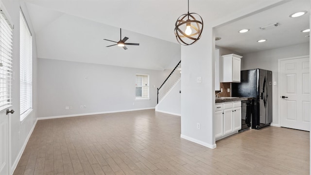 10811 Waterfern Ct, Houston, TX 77064 - kitchen featuring vaulted ceiling, a sink, white cabinetry, ceiling fan, and light wood finished floors
