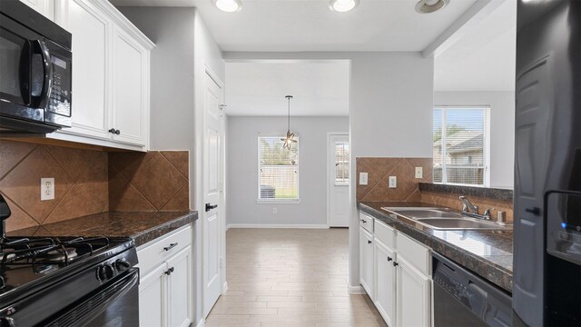10811 Waterfern Ct, Houston, TX 77064 - kitchen featuring black appliances, a sink, white cabinetry, tasteful backsplash, and baseboards