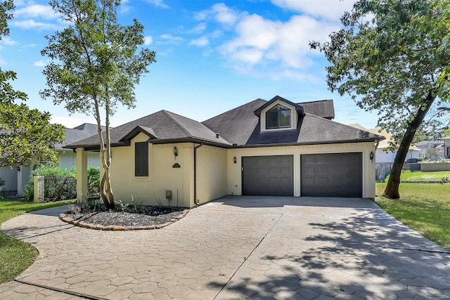 22 Creekwood Dr, Montgomery, TX 77356 - view of front of home with concrete driveway, an attached garage, stucco siding, and roof with shingles