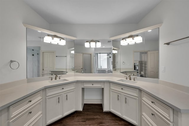 22 Creekwood Dr, Montgomery, TX 77356 - full bathroom with double vanity, an enclosed shower, and wood finished floors