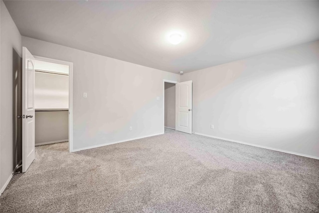5627 Rainflower Terrace Ln, Spring, TX 77389 - unfurnished bedroom with carpet floors, baseboards, and a spacious closet