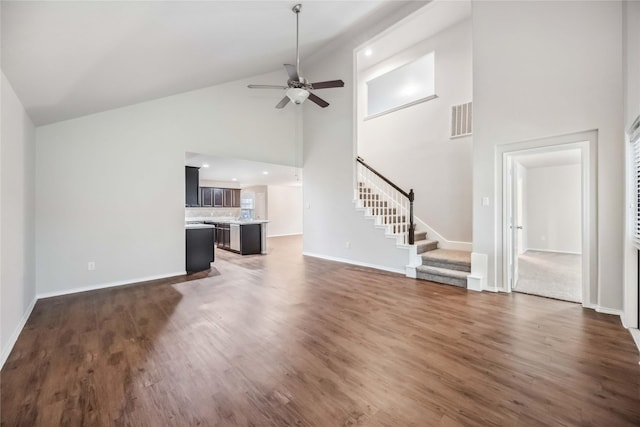 5627 Rainflower Terrace Ln, Spring, TX 77389 - unfurnished living room featuring stairway, ceiling fan, high vaulted ceiling, baseboards, and wood finished floors