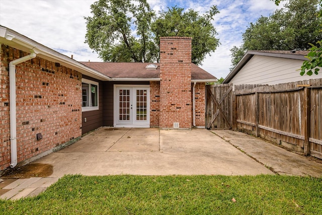 5511 Hickory Forest Dr, Houston, TX 77088 - rear view of property featuring french doors, brick siding, a chimney, a patio area, and roof with shingles