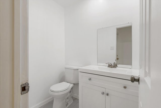 5511 Hickory Forest Dr, Houston, TX 77088 - half bathroom featuring baseboards, vanity, and toilet