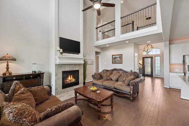 3651 Lake Bend Shore Dr, Spring, TX 77386 - living area with a high ceiling, a fireplace, hardwood / wood-style floors, and a ceiling fan