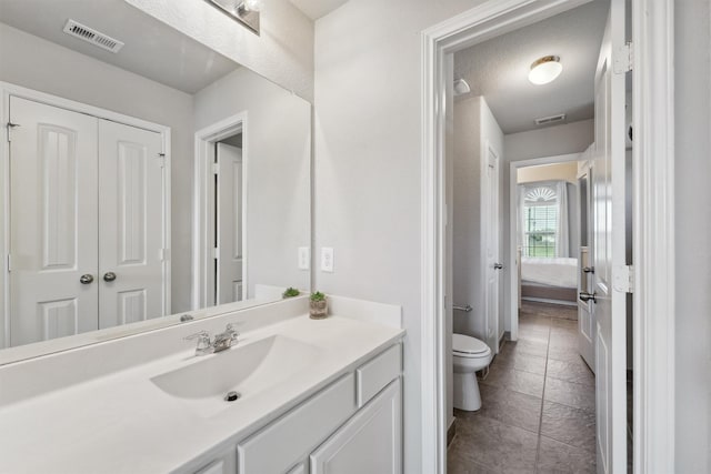 3651 Lake Bend Shore Dr, Spring, TX 77386 - bathroom with vanity, toilet, and stone tile flooring