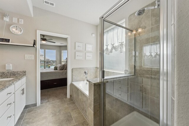 3651 Lake Bend Shore Dr, Spring, TX 77386 - bathroom with connected bathroom, vanity, a bath, a shower stall, and a ceiling fan