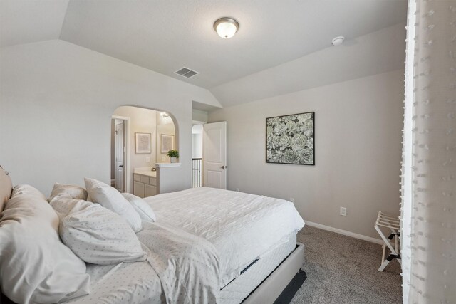 3651 Lake Bend Shore Dr, Spring, TX 77386 - bedroom featuring vaulted ceiling, arched walkways, carpet flooring, baseboards, and connected bathroom