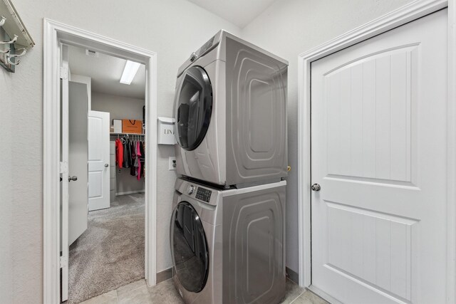3651 Lake Bend Shore Dr, Spring, TX 77386 - washroom with stacked washing machine and dryer and light colored carpet
