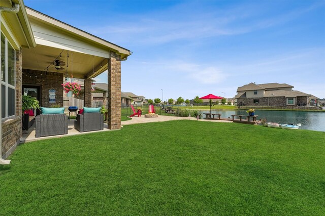 3651 Lake Bend Shore Dr, Spring, TX 77386 - view of green lawn with ceiling fan, a water view, and an outdoor living space