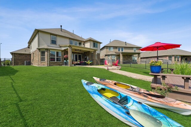 3651 Lake Bend Shore Dr, Spring, TX 77386 - back of house featuring cooling unit, brick siding, a ceiling fan, a patio area, and a wooden deck