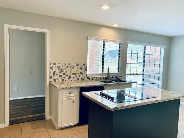 223 Kings Way, Stafford, TX 77477 - kitchen featuring a sink, dishwashing machine, black electric stovetop, white cabinets, and a center island