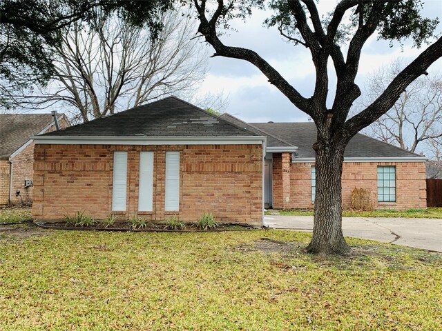 223 Kings Way, Stafford, TX 77477 - view of front of house with a front lawn, brick siding, and a shingled roof