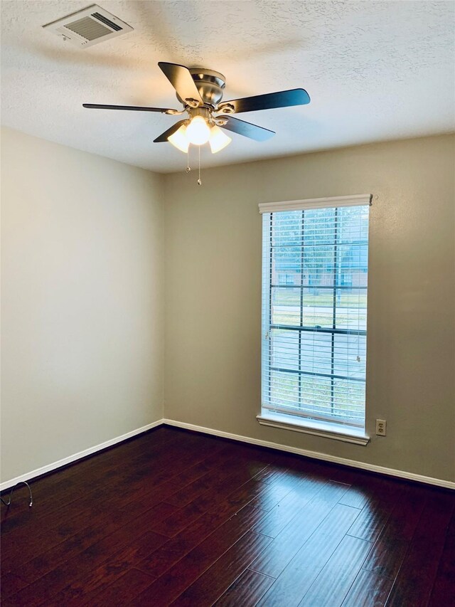 223 Kings Way, Stafford, TX 77477 - empty room with a ceiling fan, dark wood finished floors, a textured ceiling, and baseboards