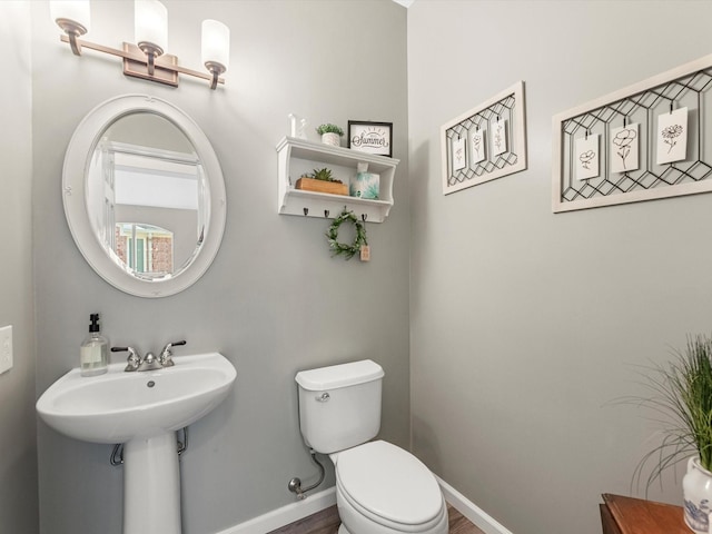 19122 High Canyon Ln, Tomball, TX 77377 - half bath with toilet, baseboards, and wood finished floors