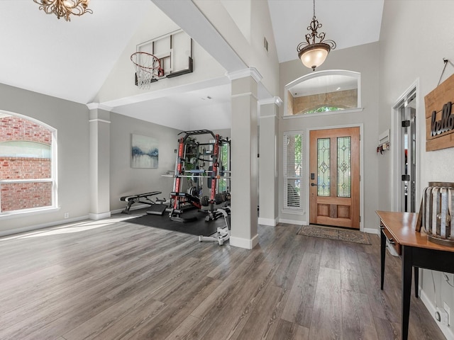 19122 High Canyon Ln, Tomball, TX 77377 - foyer featuring high vaulted ceiling, decorative columns, wood finished floors, a chandelier, and baseboards