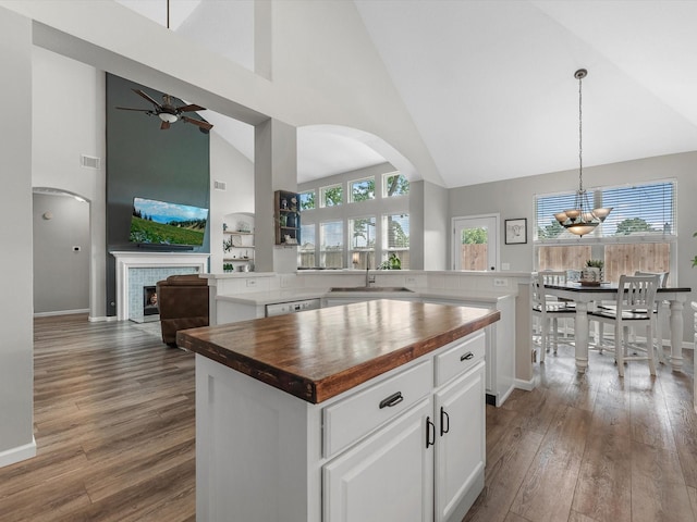 19122 High Canyon Ln, Tomball, TX 77377 - kitchen with wood counters, high vaulted ceiling, a kitchen island, a sink, and dark wood-type flooring