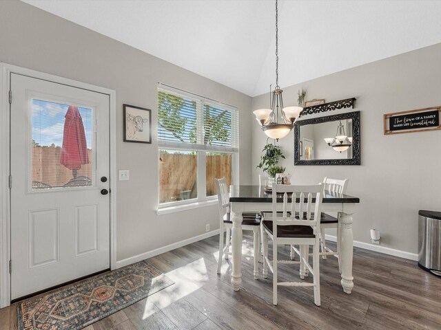 19122 High Canyon Ln, Tomball, TX 77377 - dining room with a chandelier, wood finished floors, baseboards, and lofted ceiling