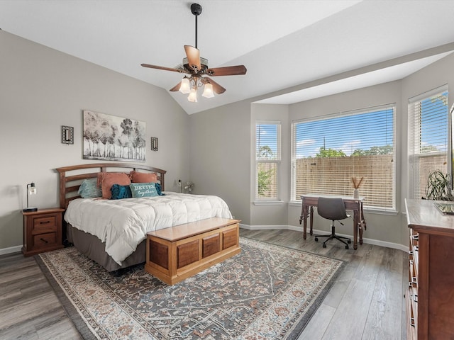 19122 High Canyon Ln, Tomball, TX 77377 - bedroom featuring multiple windows, light wood-type flooring, baseboards, and lofted ceiling